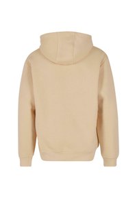 Felpa beige con una vestibilità rilassata, design a pullover, tasca a canguro e polsini a coste. Tessuto morbido, con cappuccio regolabile.