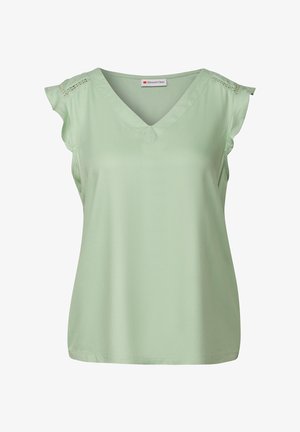 Top senza maniche di colore verde chiaro realizzato in tessuto morbido. Presenta un colletto a V e decorazioni con ricami a giorno sulle cuciture delle spalle.