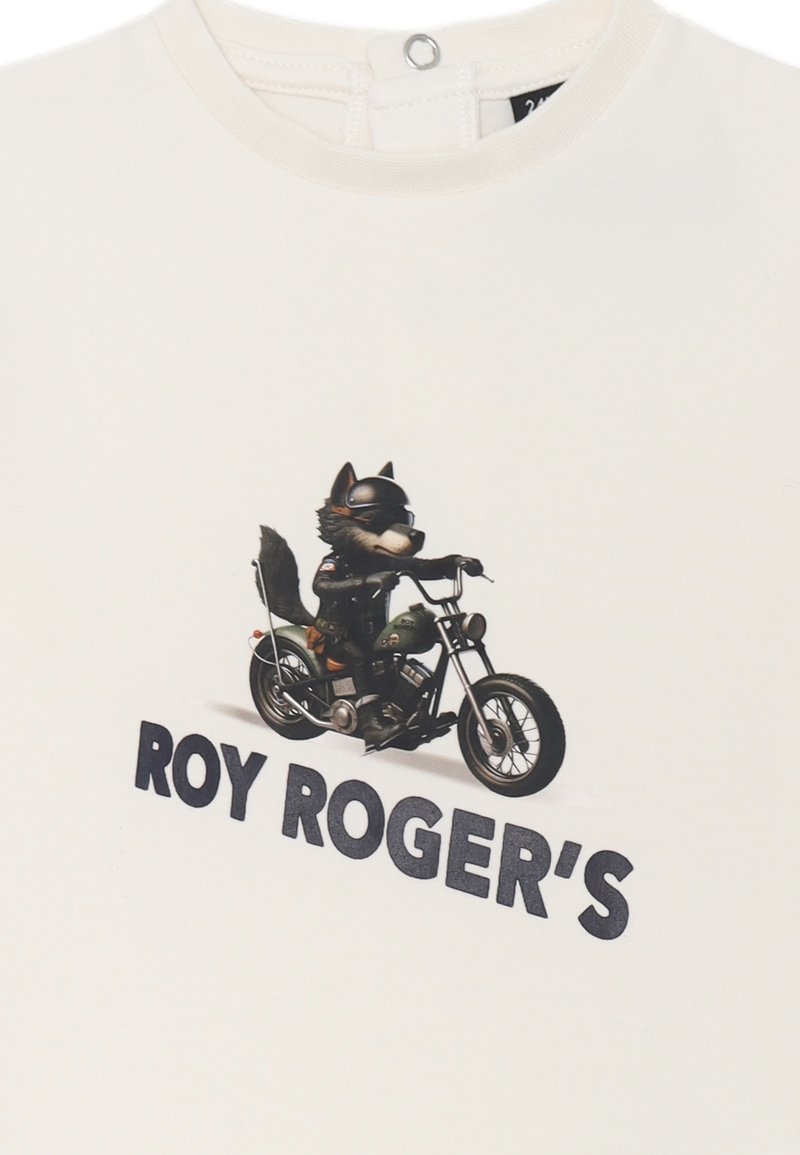 T-shirt bianca in cotone con una grafica di un lupo che indossa occhiali da sole e guida una motocicletta, con il testo "ROY ROGER'S" in bold lettere nere.