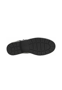 Suela de zapato de goma negra con un patrón de textura, que presenta surcos y crestas, diseñada para proporcionar tracción y durabilidad.