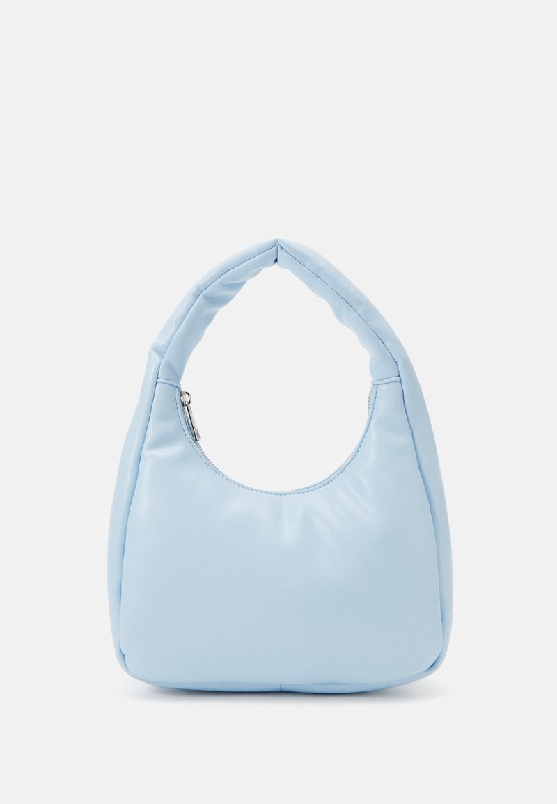 Light blue shoulder bag made of smooth material, featuring a curved handle and a rounded shape, with a zip closure on the side.