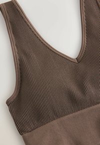 Brown ribbed tank top featuring a deep V-neckline, textured fabric with vertical lines, and smooth trim around the edges.