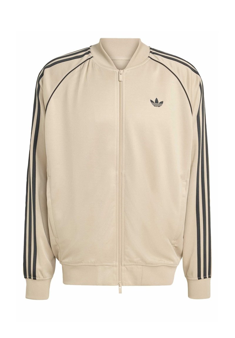 Beige zip-up jack met zwarte accenten, met twee zijzakken, geribbelde manchetten en drie zwarte strepen langs de mouwen.