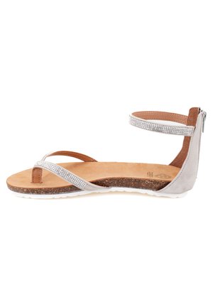 Silver embellished sandal with a soft brown footbed, cross straps, and a back zip closure. Features a textured cork sole for grip.