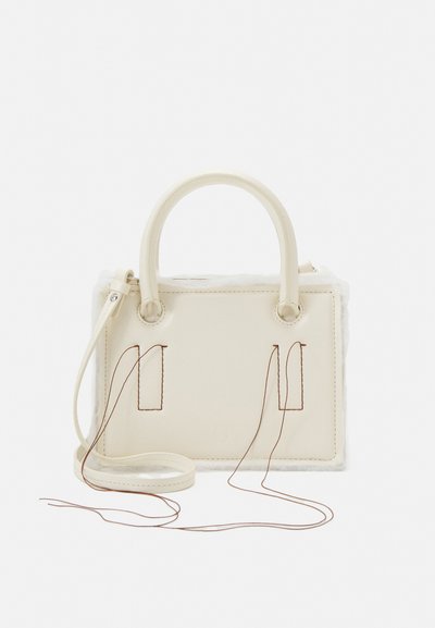 Ivory handbag made of leather and faux fur, featuring two handles, a detachable strap, and contrasting brown stitching details.