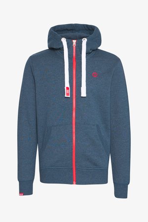 Blue hoodie with a full red zipper, white drawstrings, and red logo. Features kangaroo pocket and ribbed cuffs. Smooth, soft fabric texture.