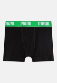 Črne bokserice iz mehke tkanine z širokim neonsko zelenim pasom, na katerem je v beli barvi napisan "PUMA". Vključujejo funkcionalno zadrgo.