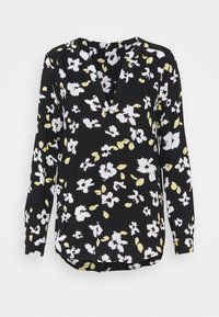 Blouse noire à manches longues avec imprimé floral abstrait blanc et jaune pâle et un décolleté en V discret.