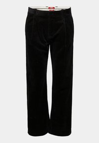 Musta corduroy suoratlahkeiset housut vyölenkeillä ja etutaskuilla vaaleanharmaata taustaa vasten.