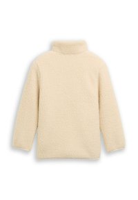 Pull en polaire couleur crème avec un col montant, des manches longues et une surface douce et texturée. Aucune fermeture ni motif visible.
