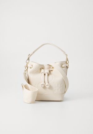 Cream bucket bag with embossed floral design, a top handle, and a detachable shoulder strap. Features gold-tone hardware and drawstring closure.