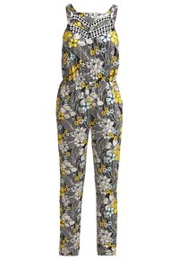 Combinaison sans manches avec taille élastique, présentant un motif de feuilles noir et blanc avec des accents floraux jaunes, blancs et bleu clair.