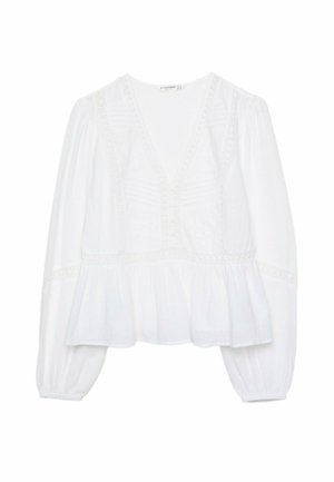 Blouse blanche avec un décolleté en V profond, des manches bouffantes longues et un ourlet péplum froncé. Des détails brodés et des boutons complètent le design.