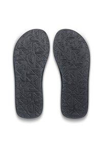 Sottili in gomma nera con pattern testurizzati che presentano forme geometriche e design di logo, progettati per comfort e stabilità.