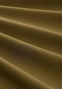 Olive green fabric with a soft, textured surface, featuring smooth, flowing waves and subtle variations in shade across the folds.