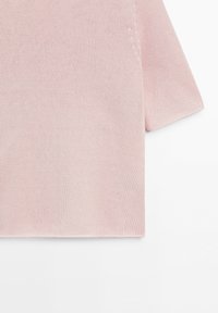 Light pink short sleeve knitted fabric shirt shown partially on a white background.