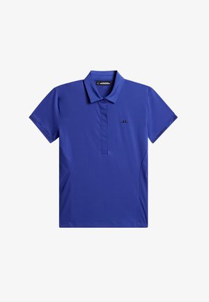 Polo shirt violet avec un col classique, des manches courtes et un panneau texturé sur les côtés. Logo imprimé sur la poitrine et la manche.