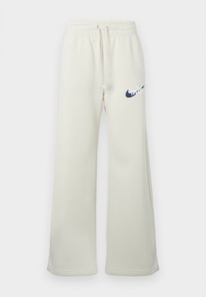 Kremne trenirke iz mešanice bombaža, z udobnim krojem, elastičnim pasom z vrvico in mornarsko modrim logotipom Nike spredaj.