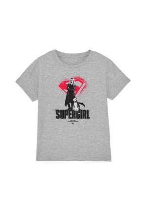 Grey t-shirt with black and red Supergirl graphic showing a woman and dog in front of a red Superman logo and "Supergirl" text below.