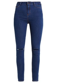 Skinny jeans made of dark blue denim with a high waist and two distressed knee rips. Features classic five-pocket design and belt loops.