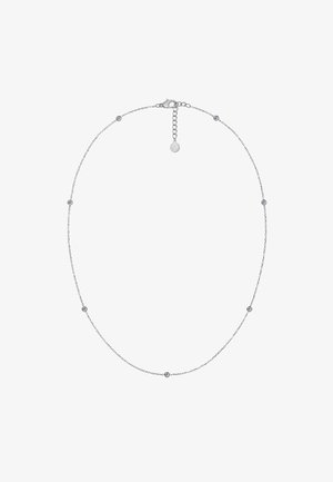 Sidabrinė grandinėlė su tolygiai išdėstytais apvaliais metaliniais akcentais ir mažais skaidriais akmenėliais. Komplekte yra vėžiuko formos užsegimas ir pratęsimo grandinėlė.