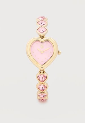 Gold wristwatch with a pink heart-shaped face and pink heart-shaped gemstones on the band, showing time 2:10.