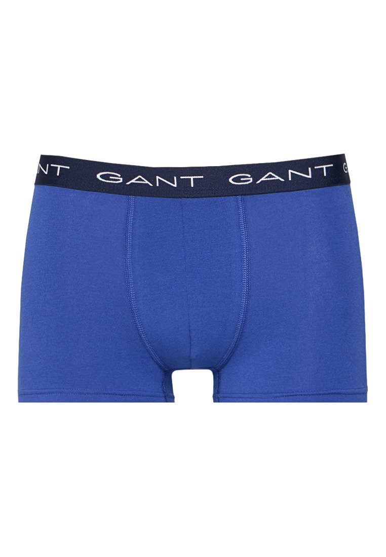 Blå boxershorts i bomull med mjuk midja som har en vit "GANT"-logotyp. Slät textur, åtsittande design och korta ben.