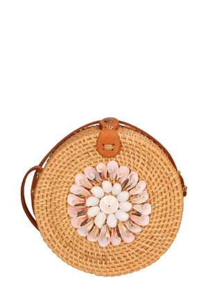 Round straw handbag with a tan leather strap, featuring a decorative shell flower design in pink and white on the front.