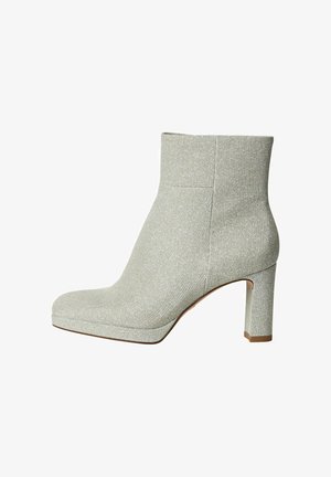Šedá kotníková bota s texturovaným, třpytivým povrchem, čtveratou špičkou a chunky podpatkem. Hladký, přiléhavý design s minimem švů.