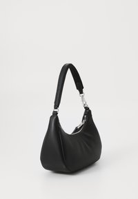 Sac à épaule en cuir noir avec une forme courbe, un corps structuré et une poche latérale zippée. Dispose d'une sangle étroite et ajustable.