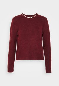 Maglione a maglia bordeaux con maniche lunghe, scollatura rotonda e dettagli in perle attorno al colletto. Presenta un orlo e polsini a coste.