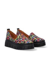 Colorful slip-on shoes with a multicolored pattern on a black base, featuring a chunky treaded sole and smooth interior.