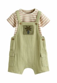 Gröna texturerade overaller med en palmträdapplikation, i kombination med en beige randig t-shirt. Har knappdetaljer och sidofickor.