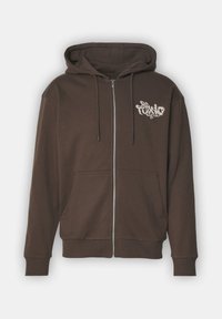 Felpa con zip marrone realizzata in tessuto misto cotone. Presenta una tasca anteriore, polsini a coste e un logo grafico bianco sul lato sinistro del petto.