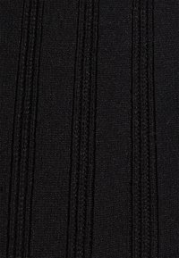 Tecido tricotado preto com textura em nervuras verticais, apresentando secções alternadas elevadas e planas, superfície suave e lisa.