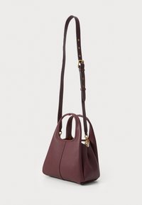 Burgundy leather handbag with a structured shape, dual handles, and an adjustable shoulder strap. Features visible stitching and gold hardware accents.