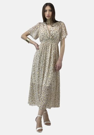 Robe maxi à motif floral en crème et jaune, avec des manches courtes volantées, un corsage ajusté et une jupe fluide. Accentuée d'un éclat subtil.