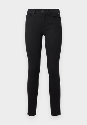Zwarte skinny jeans gemaakt van rekbare denim. Het heeft een klassiek ontwerp met vijf zakken en een standaard metalen knoopsluiting aan de taille.