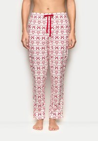 Bílé pyžamové kalhoty s červenými srd�íčky a vzorem stužek; mají elastický pas s červeným šňůrkovým stahováním; volný, pohodlný střih.