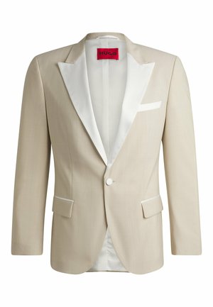 Beige formal blazer with white satin lapels, two front pockets, single button closure, and red label featuring “HUGO” on the interior.
