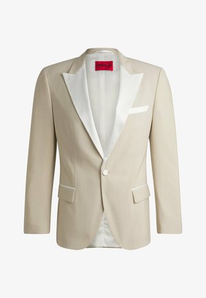 Beige formal blazer with white satin lapels, two front pockets, single button closure, and red label featuring “HUGO” on the interior.