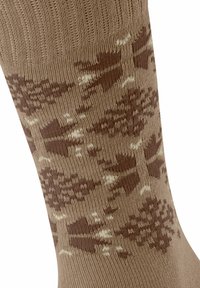 Chaussette brune à motif avec un haut côtelé texturé, ornée de motifs alternés en brun plus foncé et en crème ressemblant à des arbres ou à des flèches.