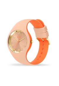 Orologio in silicone rosa con dettagli dorati, quadrante rotondo, cinturino arancione e numeri minimalisti su un quadrante rosa chiaro. Presenta una corona dorata.