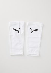 Hvide atletiske benskinner lavet af syntetisk materiale, med sorte Puma-logo accenter på begge sider, med glat overflade og tætsiddende design.