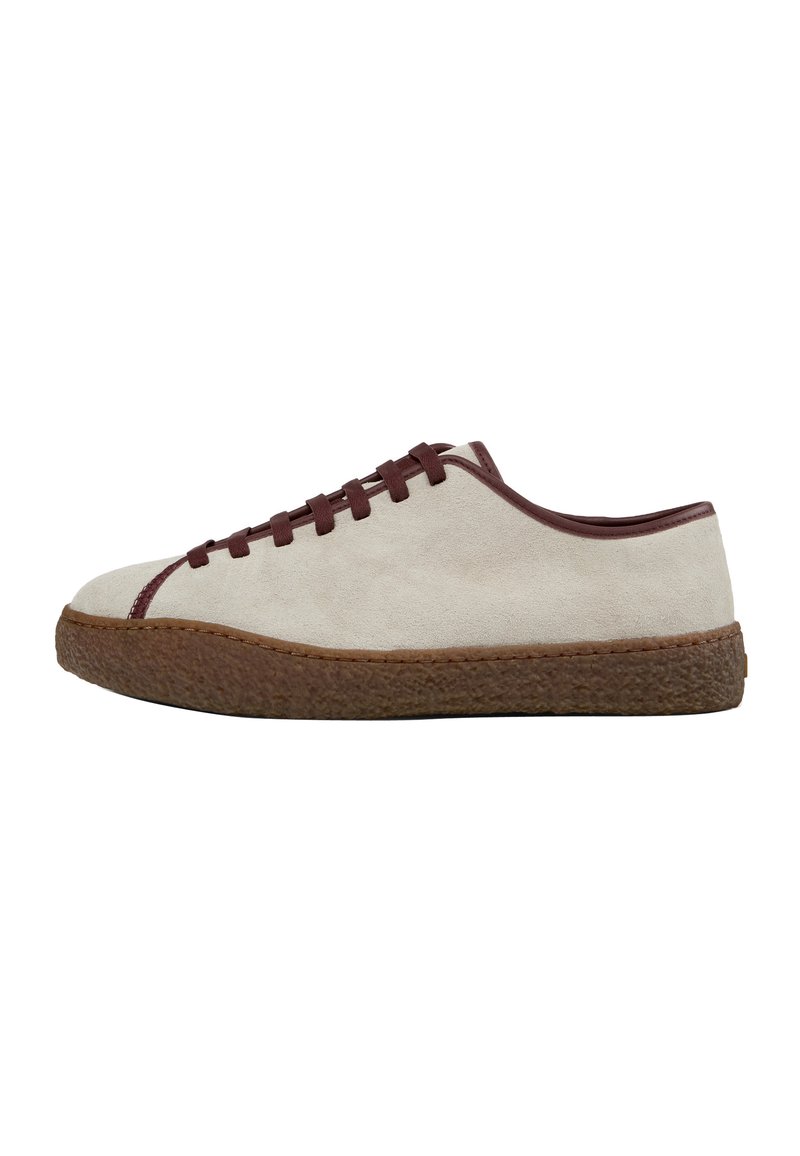 Low-top beige suede sneaker with brown rubber sole and matching brown laces and trim, side view on white background.