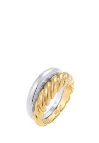 Bague torsadée en argent sterling et plaquée or avec une surface intérieure lisse et un bord festonné, mettant en valeur des couleurs et textures métalliques contrastées.