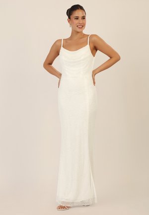 White gown with a cowl neckline, fitted silhouette, and beaded texture. Features thin straps and a long, flowing skirt with a subtle sheen.