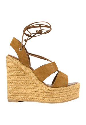 Sandale compensée en daim beige pour femme avec plateforme en jute tressée et lanières à nouer à la cheville.