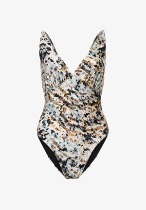 Femme aux cheveux bouclés portant un maillot de bain une pièce sans manches à encolure en V profonde avec un motif abstrait multicolore.