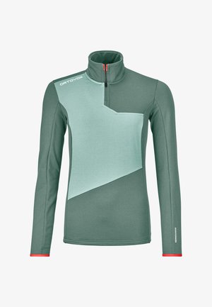 Green long-sleeve top with high collar, features a lighter mint diagonal panel, contrasting red zipper, and logo on left shoulder.